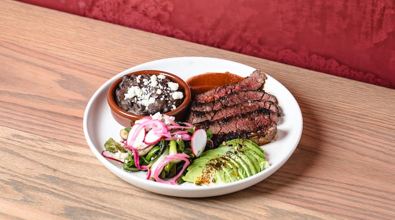 Carne asada with guajillo salsa, avocado, radish, black beans and tortillas from the Chicheria MX Kitchen menu.