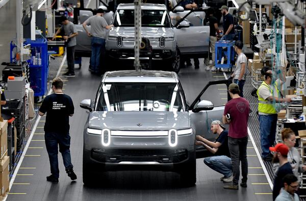 Manufacturing workers assemble electric vehicles at Rivian in Normal, Ill., on July 20, 2022. (Ron Johnson for the AJC)