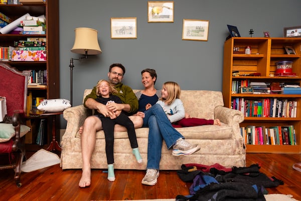 Sarah Eldridge sits with her husband, Steve Johnston, and their daughters, Isabelle and Elena, in their study at their home in Knoxville, Tenn., on Tuesday, Oct. 29, 2025. (Courtesy of Jared Worsham)