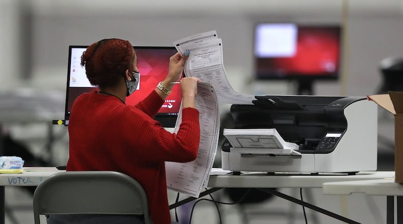 DeKalb County election workers scan ballots to recount more votes in the 2020 presidential election. Curtis Compton / Curtis.Compton@ajc.com