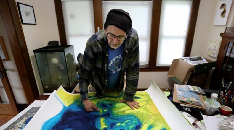 Sean Connaughty, considered by many to be Lake Hiawatha’s personal caretaker, studies his painting of the lake and surrounding area, including the nearby Hiawatha Golf Course. David Joles/Minneapolis Star Tribune/TNS