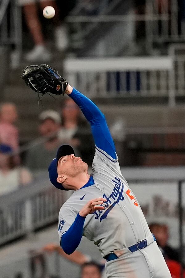 Los Angeles Dodgers first baseman Freddie Freeman (5) makes the catch against Atlanta Braves' Nick Allen in the nineth inning of a baseball game, Friday, May 2, 2025, in Atlanta. (AP Photo/Mike Stewart)