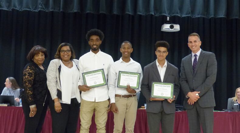 From left to right, Fulton County School Board President Linda Bryant, Westlake High School Principal Alexanda Bates, Abdullah Robins, Owen Manning, Xavier Maldonado and Superintendent Jeff Rose. On March 23, the board recognized the three scholarship winners.