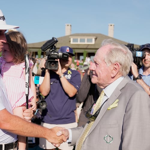 J.T. Poston shakes hands with Jack Nicklaus after winning the Memorial golf tournament, Sunday, June 7, 2026, in Dublin, Ohio. (AP Photo/Sue Ogrocki)