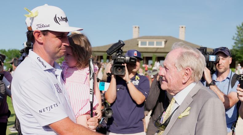 J.T. Poston shakes hands with Jack Nicklaus after winning the Memorial golf tournament, Sunday, June 7, 2026, in Dublin, Ohio. (AP Photo/Sue Ogrocki)