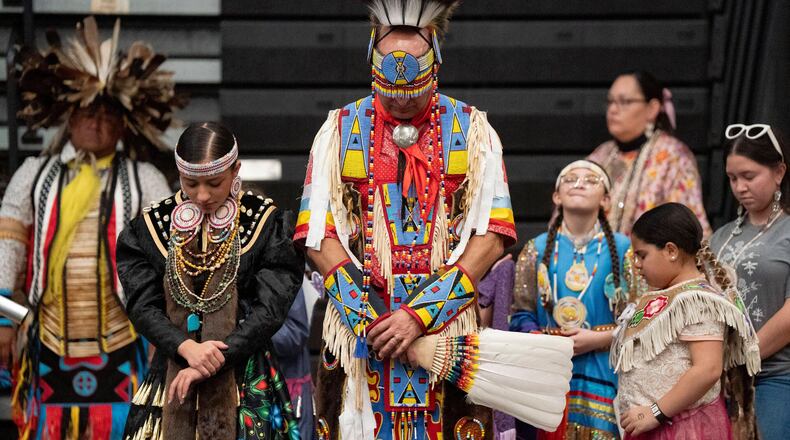 FILE - Members of the Lumbee Tribe bow their heads in prayer during the BraveNation Powwow and Gather at UNC Pembroke, March 22, 2025, in Pembroke, N.C. (AP Photo/Allison Joyce, file)
