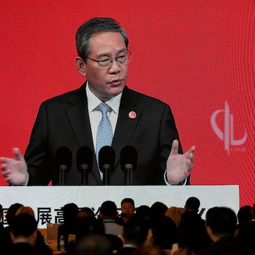 Chinese Premier Li Qiang is displayed on a large screen live broadcasting his speech at the opening of the China Development Forum 2026 held at the Diaoyutai State Guesthouse in Beijing on Sunday, March 22, 2026. (AP Photo/Ng Han Guan, Pool)
