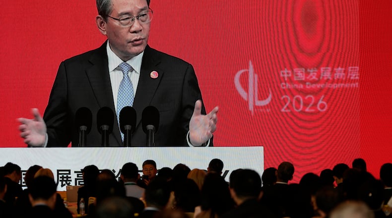 Chinese Premier Li Qiang is displayed on a large screen live broadcasting his speech at the opening of the China Development Forum 2026 held at the Diaoyutai State Guesthouse in Beijing on Sunday, March 22, 2026. (AP Photo/Ng Han Guan, Pool)