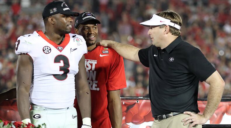 January 1, 2018 Pasadena: Kirby Smart stands on stage with Roquan Smith and Nick Chubb after beating Oklahoma 54-48 during double over time in the College Football Playoff Semifinal at the Rose Bowl Game on Monday, January 1, 2018, in Pasadena.    Curtis Compton/ccompton@ajc.com