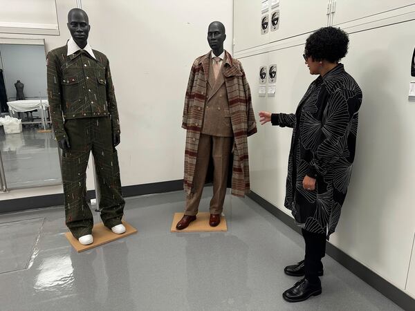 Monica L. Miller, guest curator of the upcoming Costume Institute exhibit “Superfine: Tailoring Black Style," looks over designs in the installation room at the Metropolitan Museum of Art in New York on March 20, 2025. (AP Photo/Jocelyn Noveck)