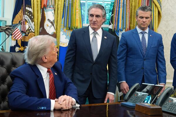 President Donald Trump and Defense Secretary Pete Hegseth listen as Commerce Secretary Howard Lutnick speaks in the Oval Office of the White House, Friday, May 23, 2025, in Washington. (AP Photo/Evan Vucci)