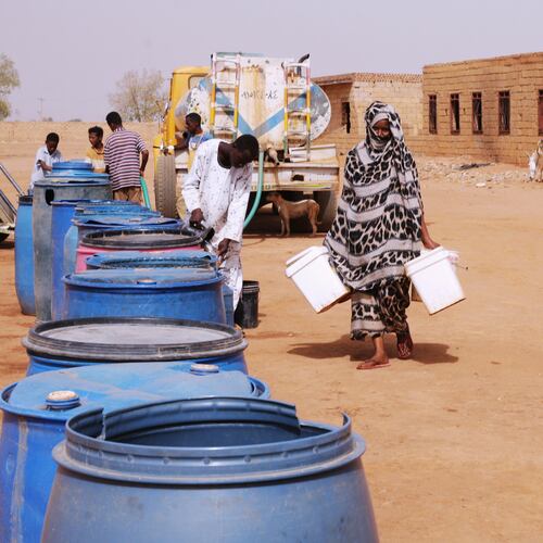 FILE - People fill water containers at a free distribution point amid water outages in Khartoum, Sudan, May 18, 2026. (AP Photo/Marwan Ali, File)