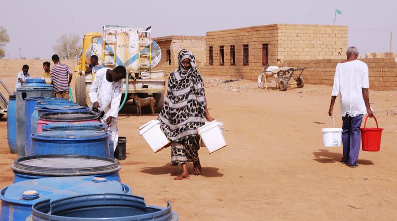 FILE - People fill water containers at a free distribution point amid water outages in Khartoum, Sudan, May 18, 2026. (AP Photo/Marwan Ali, File)