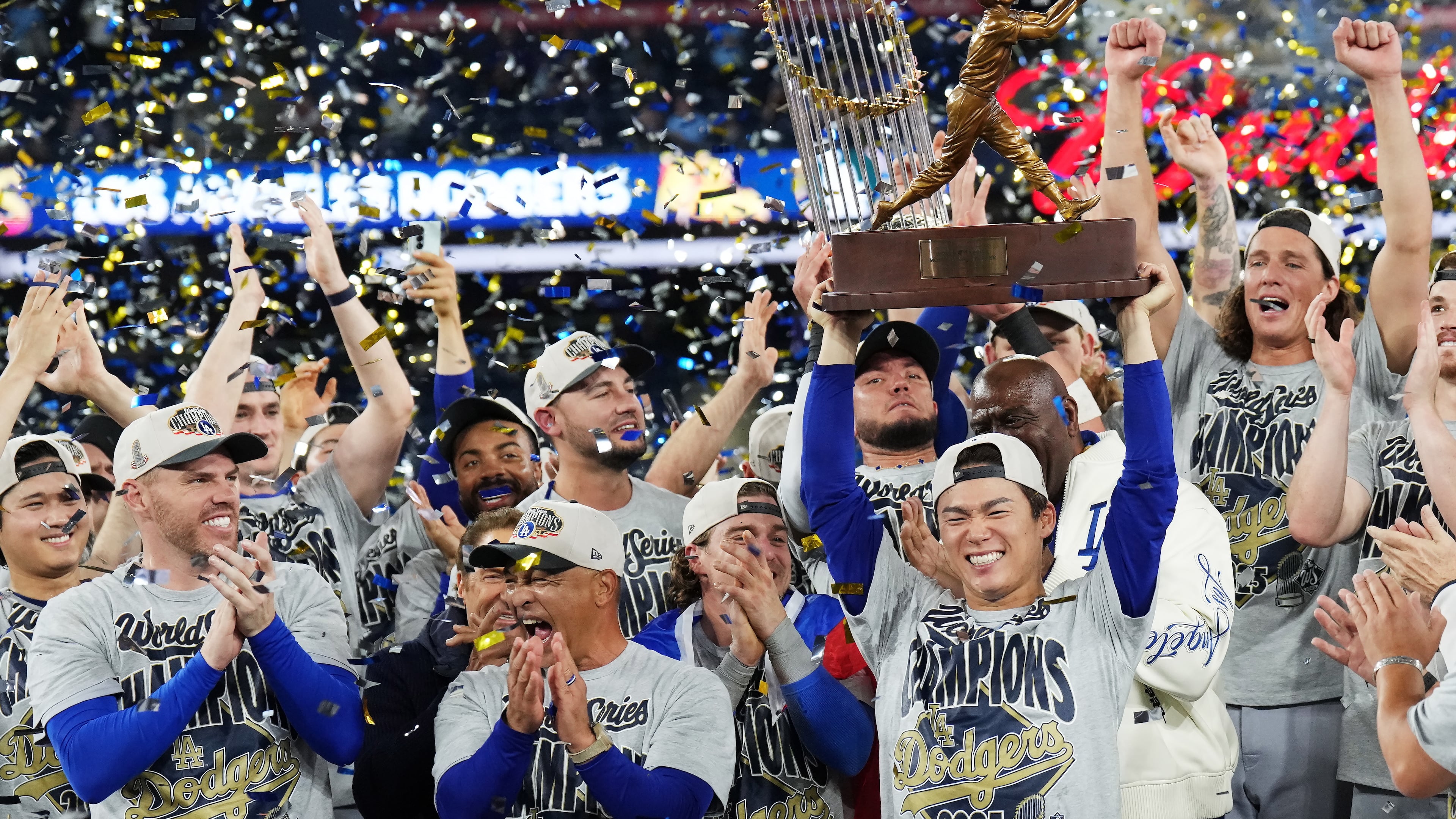 Los Angeles Dodgers pitcher Yoshinobu Yamamoto, center right, lifts the World Series MVP trophy as the Dodgers celebrate after defeating the Toronto Blue Jays in Game 7 of baseball's World Series, Sunday, Nov. 2, 2025, in Toronto. (Nathan Denette/The Canadian Press via AP)