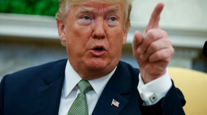 President Donald Trump talks with reporters in the Oval Office March 15, 2018. (AP Photo/Evan Vucci)