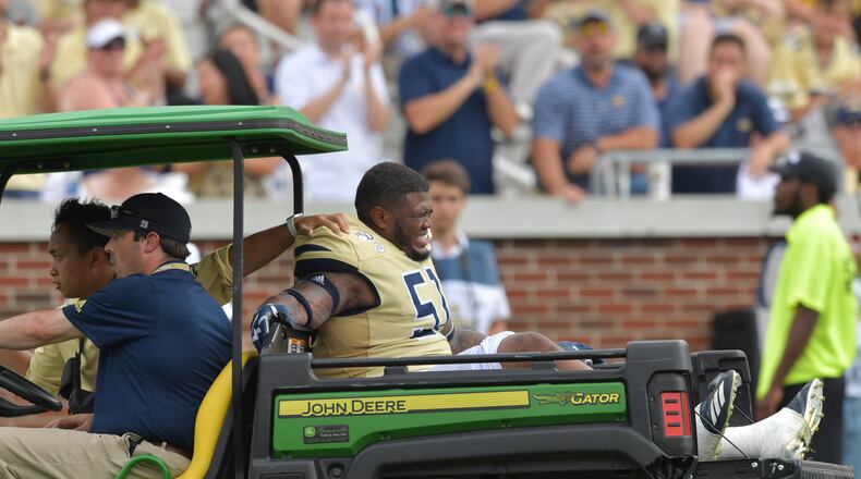 Georgia Tech defensive lineman Jahaziel Lee (51) reacts as he is carried off the field after his injury. (Hyosub Shin / Hyosub.Shin@ajc.com)