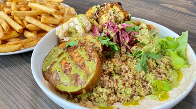 The rotisserie cauliflower and fried eggplant bowl, with a side of fries, at the Daily Chew.
Wendell Brock for The Atlanta Journal-Constitution