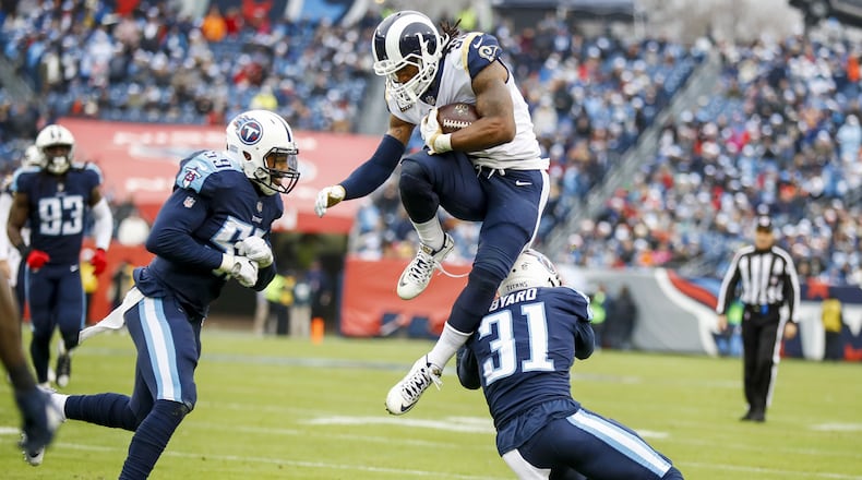Los Angeles Rams running back Todd Gurley jumps over Tennessee safety Kevin Byard in a game last month.