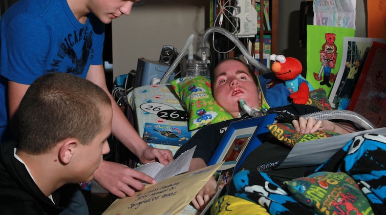 Lucas Hoelscher, a 14-year-old Springfield resident, suffers from spinal muscular atrophy type I, and the disease has left him with zero movement. When he was 10 months old, doctors told him he wouldn't live past age one. Lucas, part of triplet brothers Bailey (top) and Cameron (lower left), enjoys receiving mail and correspondence from near and far. JIM WITMER / STAFF