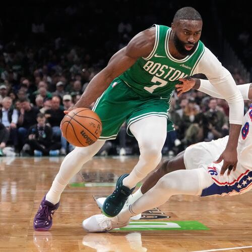 FILE - Boston Celtics guard Jaylen Brown (7) drives to the basket against Philadelphia 76ers forward Paul George (8) during the first half of Game 2 of a first-round NBA playoffs basketball series, April 21, 2026, in Boston. (AP Photo/Charles Krupa, File)