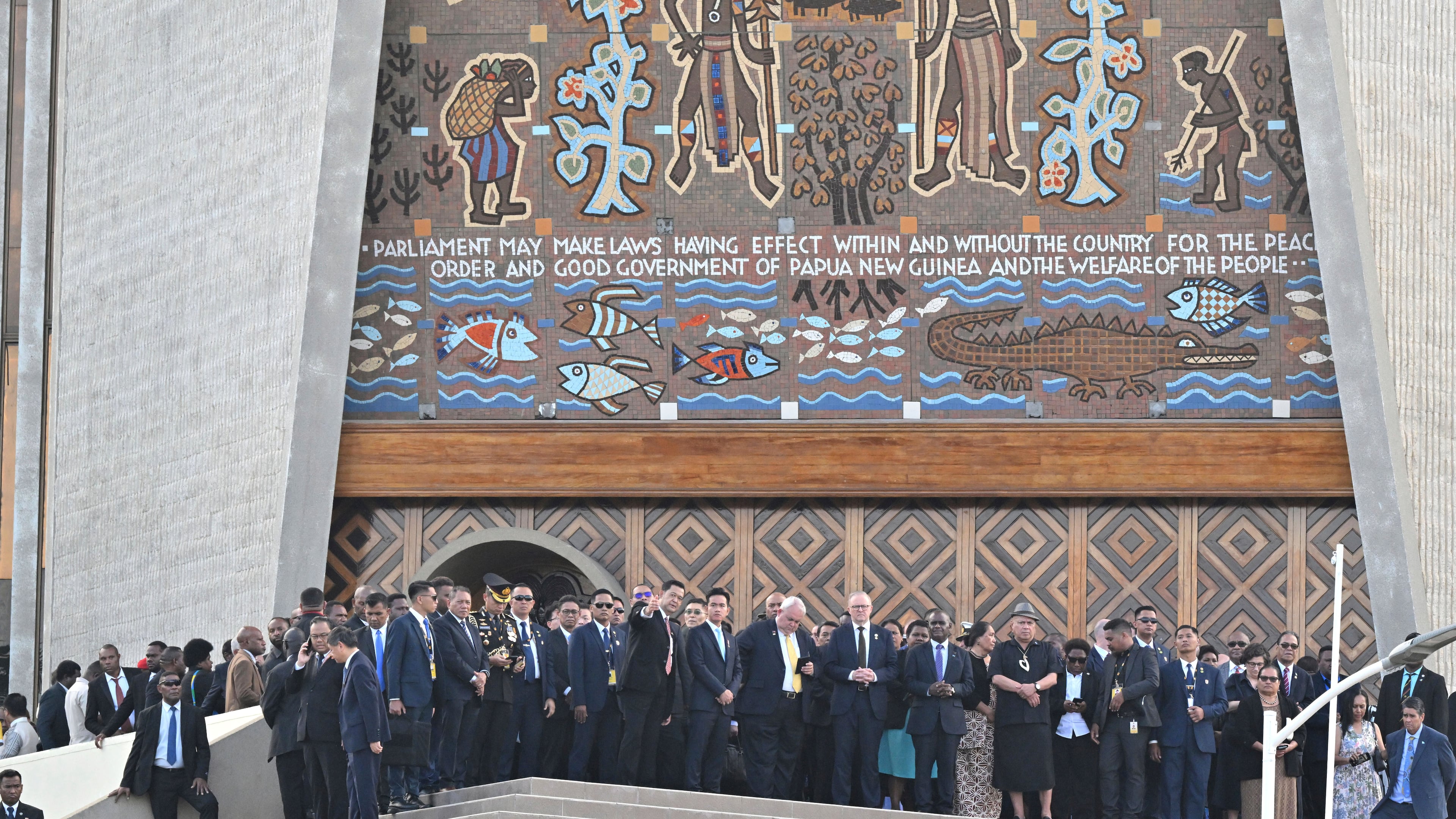 Australian Prime Minister Anthony Albanese, center right, and other dignitaries stand in front of Parliament House after a flag raising ceremony in Port Moresby, Papua New Guinea, Tuesday, Sept. 16, 2025. (Mick Tsikas/AAP Image via AP)