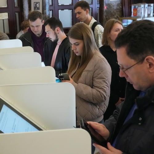 Voters use an electronic voting system in the parliamentary election in Moscow, Friday, Sept. 18, 2026. (AP Photo/Pavel Bednyakov)