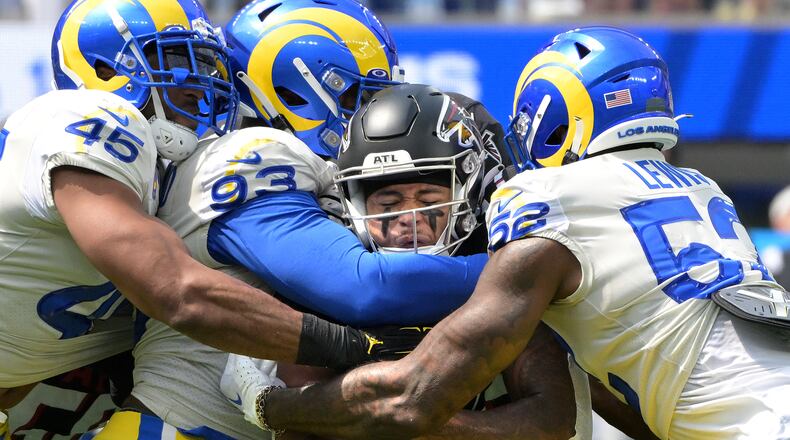 Los Angeles Rams defenders Bobby Wagner (45), Marquise Copeland (93) and Terrell Lewis stop Atlanta Falcons running back Tyler Allgeier in the first quarter at SoFi Stadium Sunday, Sept. 18, 2022, in Inglewood, California. (Wally Skalij/Los Angeles Times/TNS)