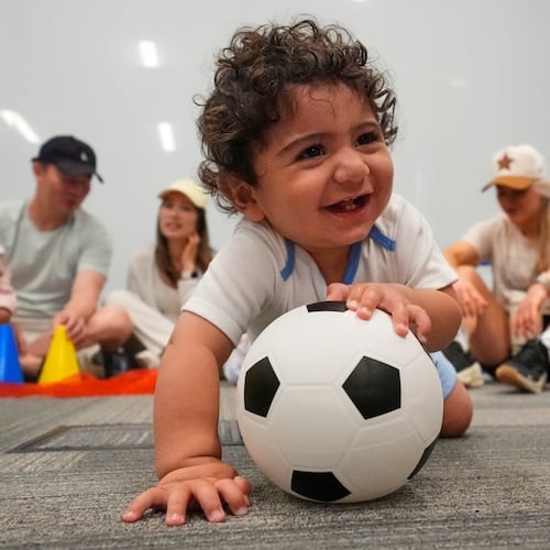 Ten-month-old Zain Fawaz plays with a soccer ball at a program introducing toddlers to the sport ahead of the World Cup soccer tournament Thursday, June 4, 2026, in Lenexa, Kan. (AP Photo/Charlie Riedel)