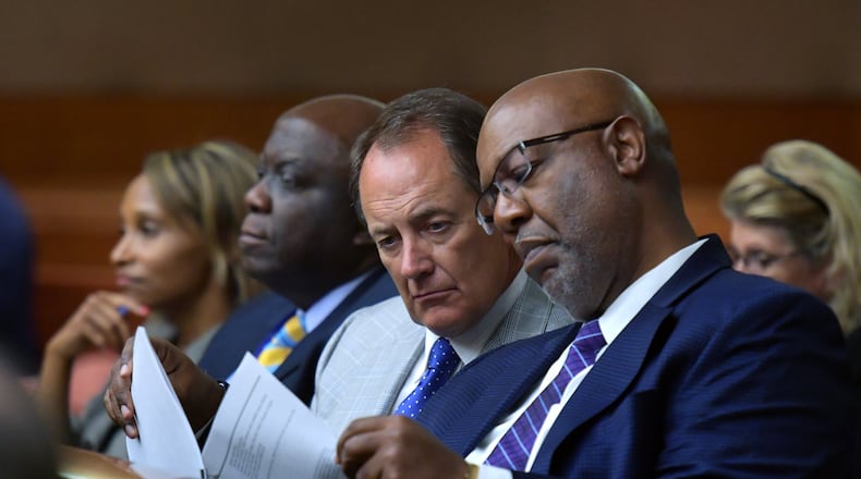 Fulton County Manager Dick Anderson and Dwight Robinson (right), Fulton County’s chief appraiser, share documentation as they listen in August 2018 during a hearing on whether Fulton County could collect tax money amid a dispute with the state over the county’s property assessments.