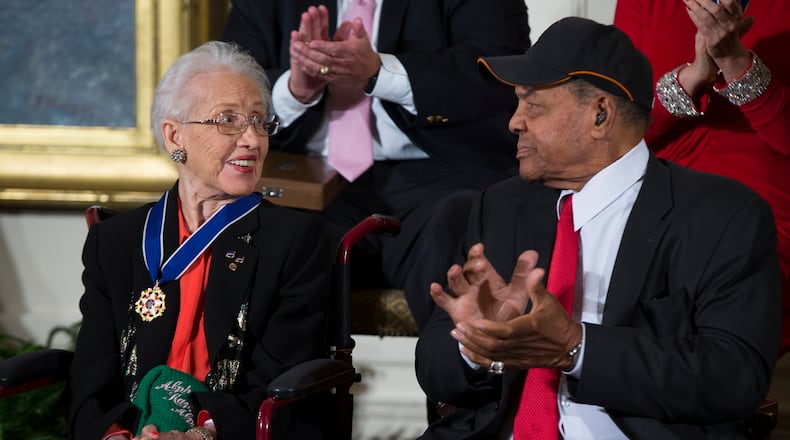 Katherine Johnson is a physicist, space scientist, and mathematician who contributed to America's aeronautics and space programs with the early application of digital electronic computers at NASA. Known for accuracy in computerized celestial navigation, she calculated the trajectory for Project Mercury and the 1969 Apollo 11 flight to the Moon. In 2015, President Barack Obama presented her with the Presidential Medal of Freedom. (AP Photo/Evan Vucci)
