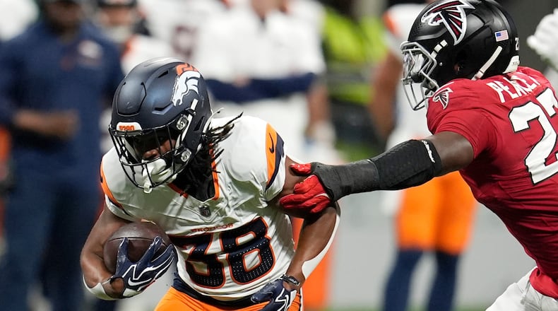Denver Broncos running back Jaleel McLaughlin (left) runs against Atlanta Falcons linebacker James Pearce Jr. (right) during the first half of a preseason NFL football game, Friday, Aug. 14, 2026, in Atlanta. (Mike Stewart/AP)