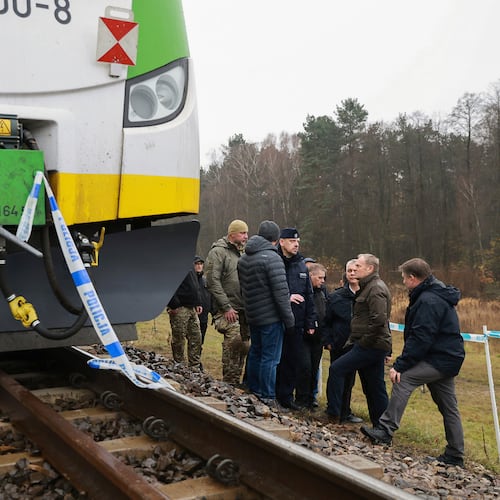Prime Minister Donald Tusk, second right, visits site of the rail line Mika, that was damaged by sabotage, near Deblin, Poland, Monday, Nov. 17, 2025. (AP Photo/KPRM)