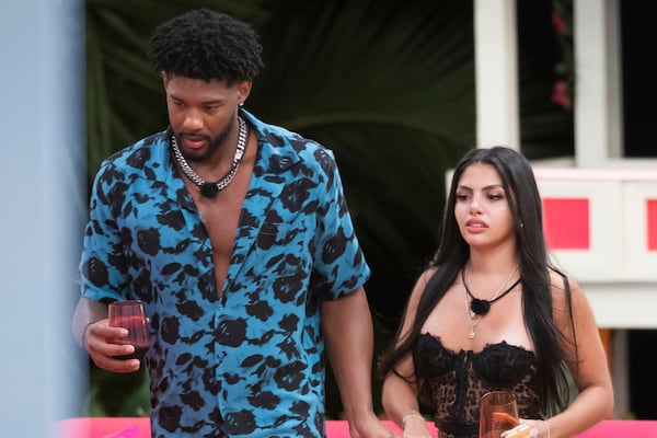 This image released by Peacock shows Chris Seeley, left, and Huda Mustafa from the reality series "Love Island USA." (Ben Symons/Peacock via AP)