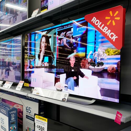 FILE - In this Nov. 9, 2018, file photo shoppers look at televisions at a Walmart Supercenter in Houston. (AP Photo/David J. Phillip, File)