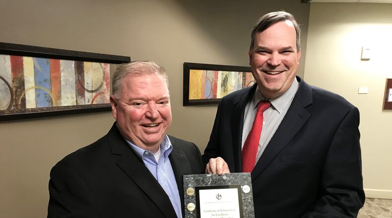 City of Dunwoody Finance Director Chris Pike (left) and Dunwoody City Manager Eric Linton accept city award for excellence in financial reporting. CONTRIBUTED