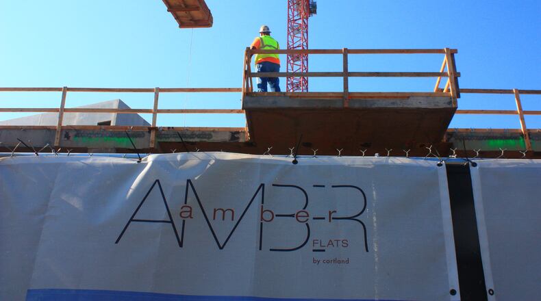 Buildings are still rising in Atlanta, like this mixed-used project at MARTA’s Avondale station, but banks’ lending to developers and many other borrowers has slowed substantially in recent months. Photo: Russell Grantham/AJC staff