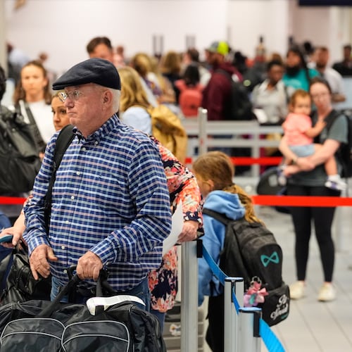 Travelers stand in line at a ticketing gate at the Dallas Fort Worth International Airport, at DFW Airport, Texas, Friday, Nov. 21, 2025. (AP Photo/Tony Gutierrez)