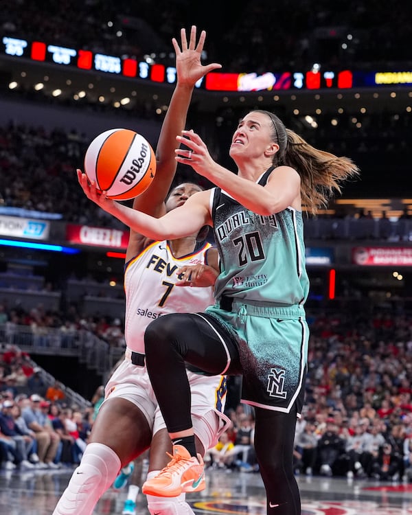 New York Liberty guard Sabrina Ionescu (20) shoots in front of Indiana Fever forward Aliyah Boston (7) in the first half of a WNBA basketball game in Indianapolis, Saturday, May 24, 2025. (AP Photo/Michael Conroy)