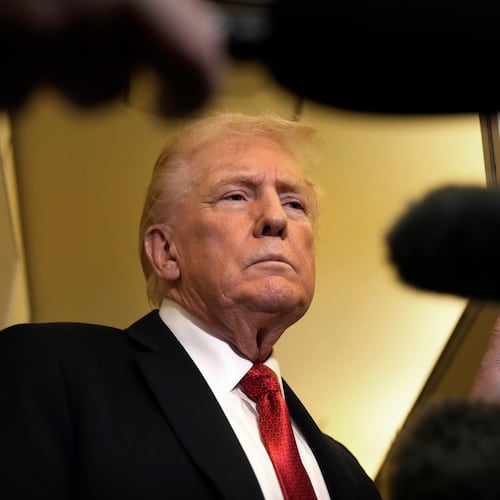 President Donald Trump speaks to reporters aboard Air Force One, Sunday, Oct. 19, 2025, en route to Joint Base Andrews, Md., as he returns from a trip to Florida. (AP Photo/Mark Schiefelbein)