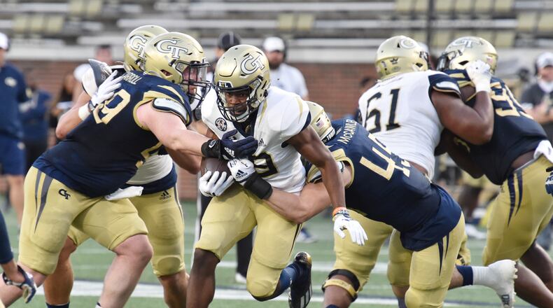 Georgia Tech running back Englan Williams gets tackled by Georgia Tech defensive lineman Grey Carroll (49) and Georgia Tech linebacker Taylor McCawley (45) during the 2022 spring game. The potential for Georgia Tech athletes to earn money off their name, image and likeness is about to increase. (Hyosub Shin / Hyosub.Shin@ajc.com)