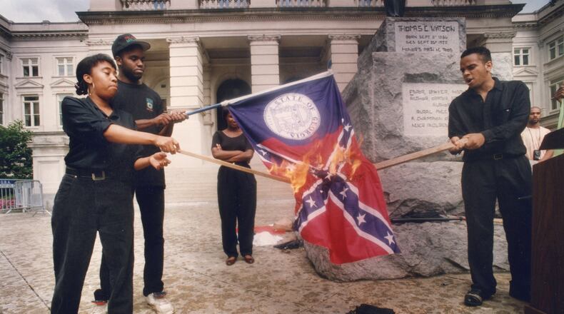 Burning Georgia's "racist past" is how Lawrence Jeffries (right) described the flag-burning Sunday at the Capitol. From left are the Ina Solomon, Jeffery Harris and Stacey Abrams in June 1992. (W.A. Bridges Jr./The Atlanta Journal-Constitution)
