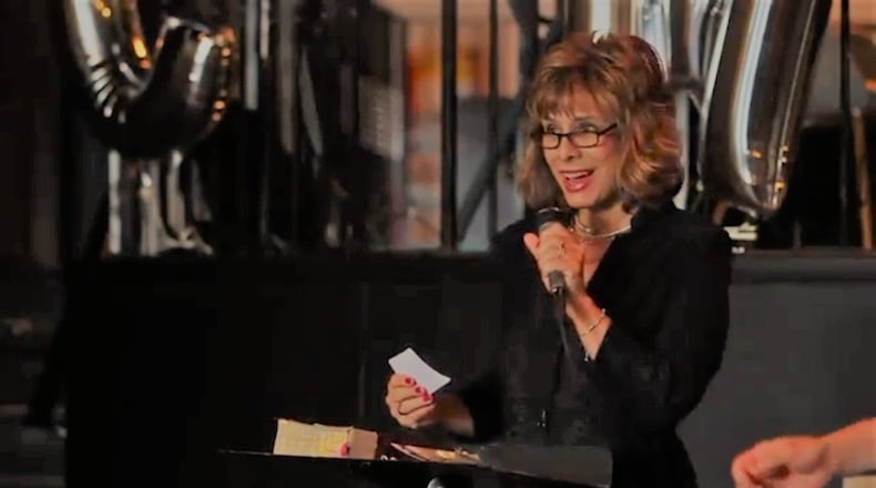 Angie Racine, founder of 4 Hope, recites a poem, “4 Hope From Hurting to Healing,” during the Second Annual Purple Tape Project held recently. Racine says she suffered emotional abuse for years but didn’t realize it until years later. CONTRIBUTED