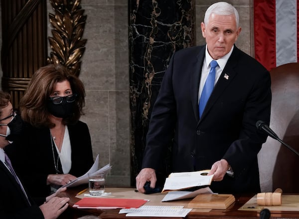 FILE - Vice President Mike Pence stands to officiate with Speaker of the House Nancy Pelosi, D-Calif., as a joint session of the House and Senate convenes to count the Electoral College votes cast in November's election, at the Capitol in Washington, Jan. 6, 2021. (AP Photo/J. Scott Applewhite, File)