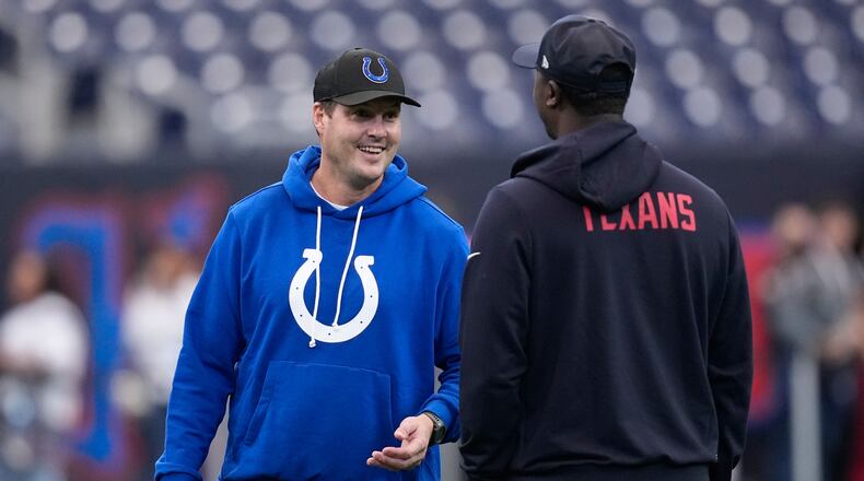 Indianapolis Colts quarterback Philip Rivers, left, visits before an NFL football game against the Houston Texans in Houston, Sunday, Jan. 4, 2026. (AP Photo/David J. Phillip)