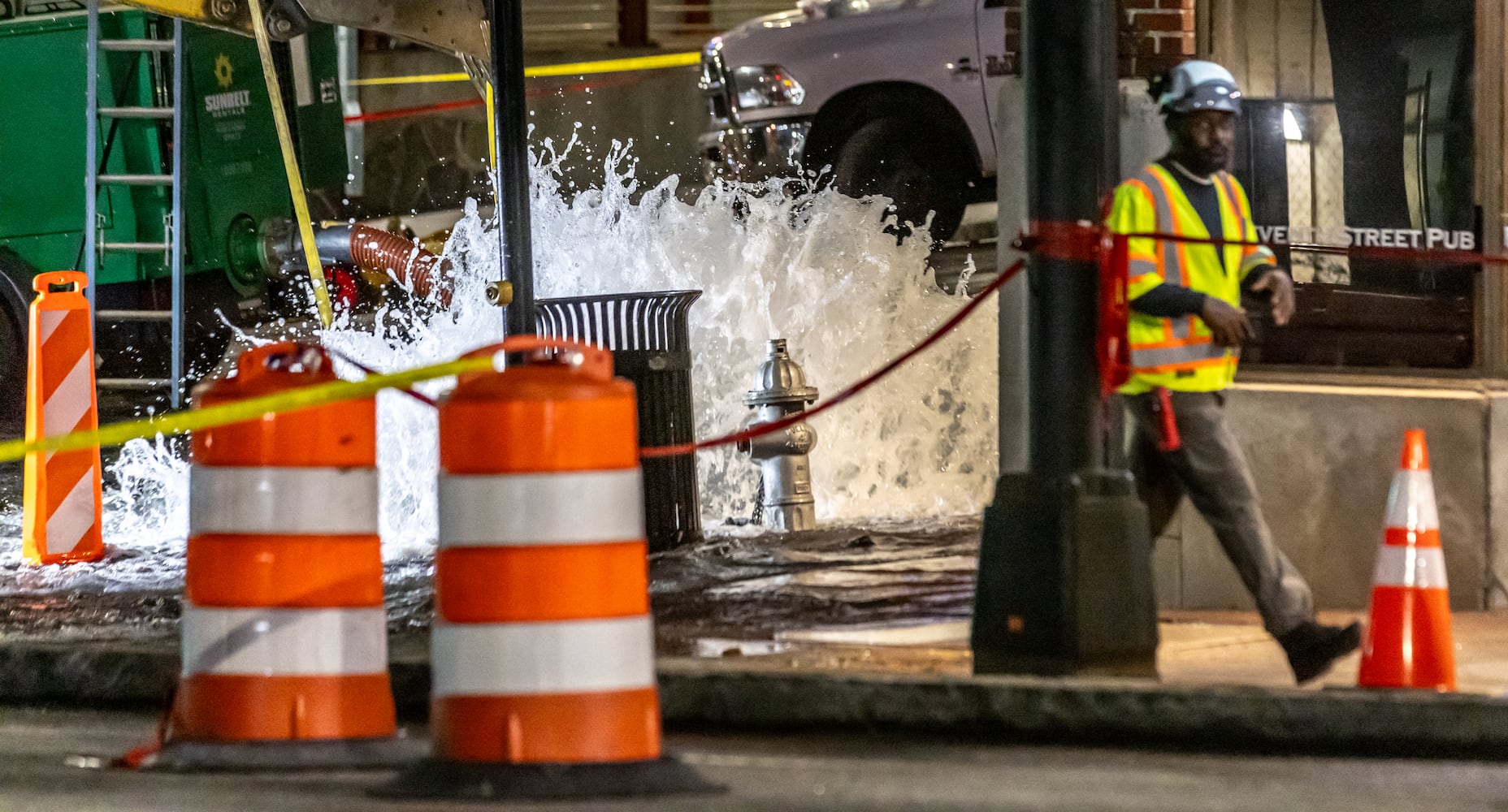 Crews are continuing to work on a broken main on West Peachtree Street at 11th Street in Midtown, with nearby residents warned of impacts to their water service as the crisis reached its fourth day Monday, June 3, 2024. Water had been gushing out of the broken main until Monday morning, when workers were seen pumping out water. (John Spink/AJC)
