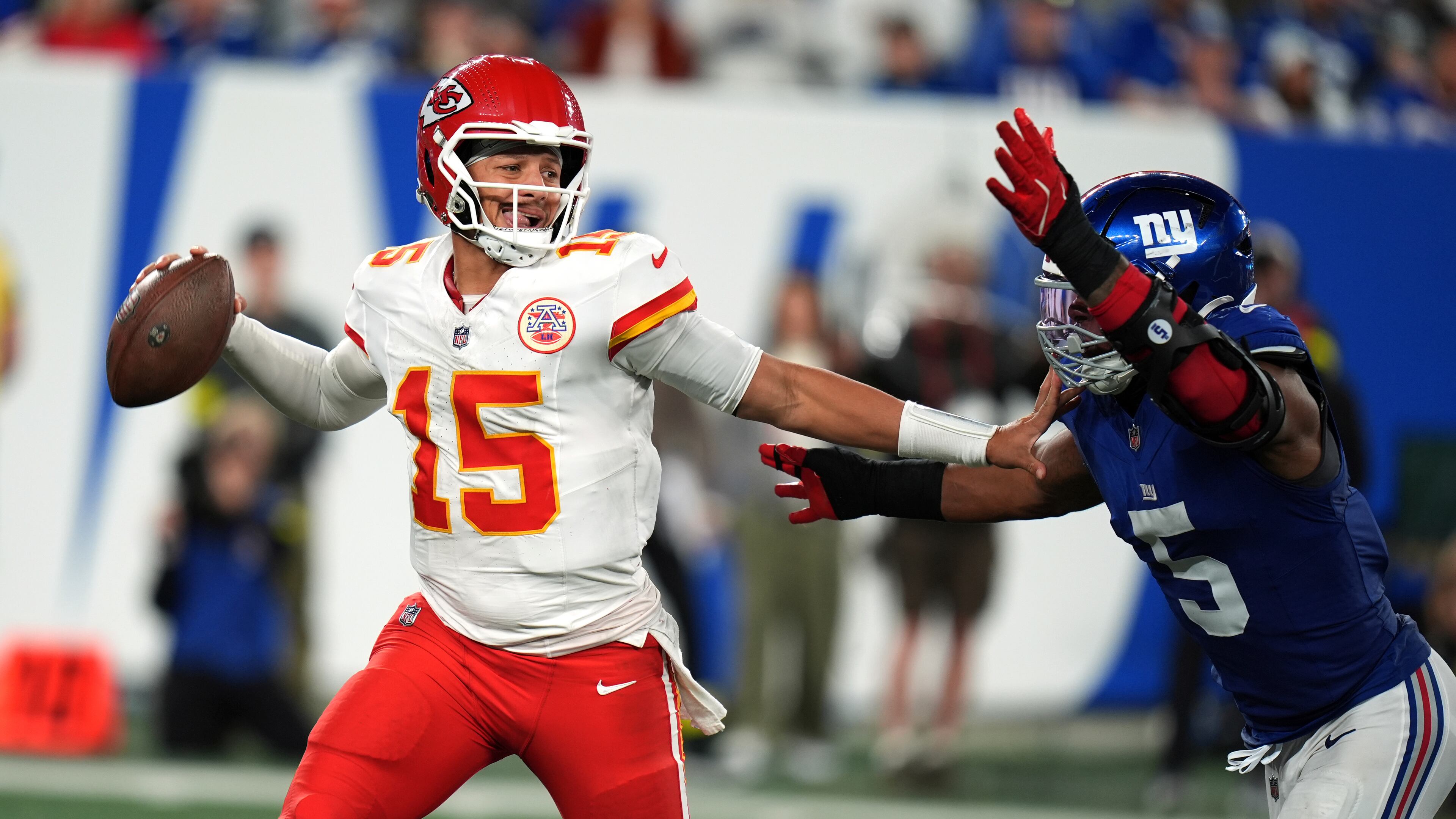 Kansas City Chiefs quarterback Patrick Mahomes throws as New York Giants outside linebacker Kayvon Thibodeaux (5) defends during the second half of an NFL football game Sunday, Sept. 21, 2025, in East Rutherford, N.J. (AP Photo/Seth Wenig)
