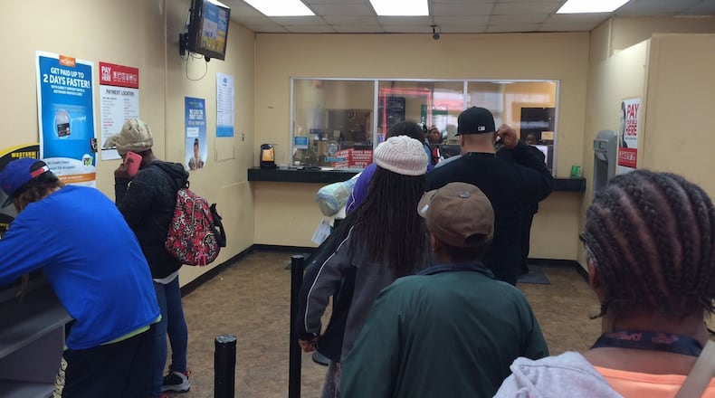 The interior of Atlanta Check Cashers in downtown Atlanta is often filled with people who have no other choice but to do business there. Photo by Bill Torpy