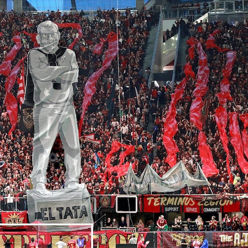 Atlanta United fans raise an image of head coach Gerardo “Tata” Martino to start the game against New York City during the first half in their MLS Eastern Conference Semifinal playoff match in Atlanta. (File AJC)