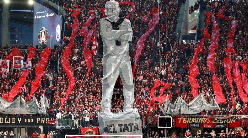 Atlanta United fans raise an image of head coach Gerardo “Tata” Martino to start the game against New York City during the first half in their MLS Eastern Conference Semifinal playoff match in Atlanta. (File AJC)