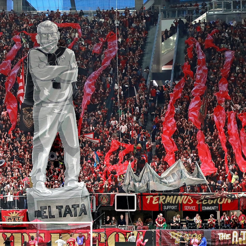 Atlanta United fans raise an image of head coach Gerardo “Tata” Martino to start the game against New York City during the first half in their MLS Eastern Conference Semifinal playoff match in Atlanta. (File AJC)